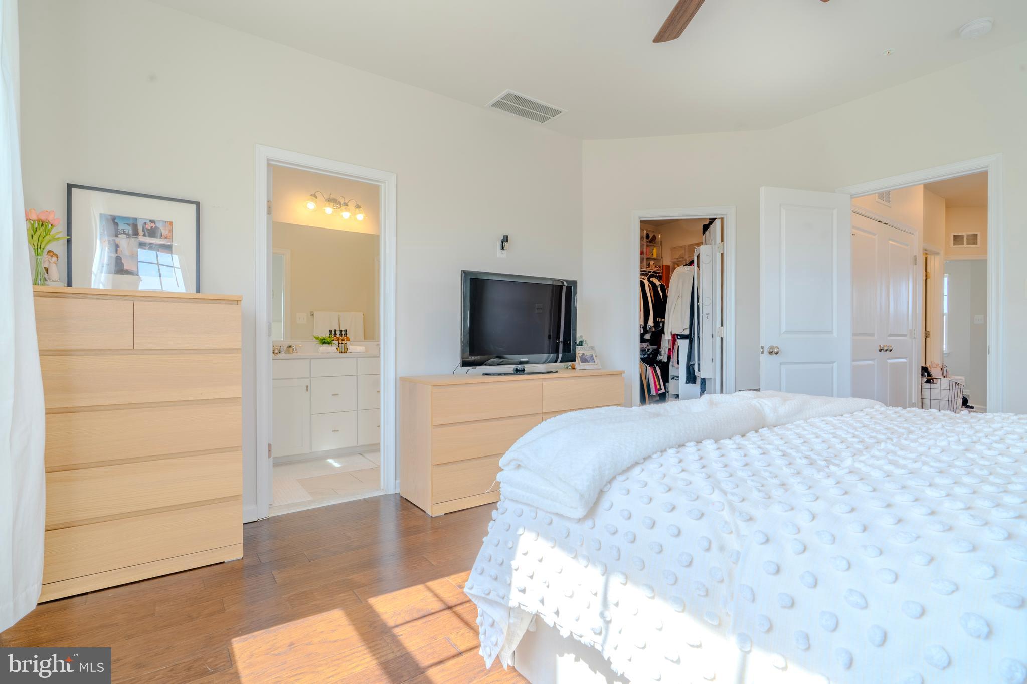 8515 Bald Eagle Lane Frederick, MD 21704 - Photo 23 of 34 a bedroom with a bed and a flat screen tv