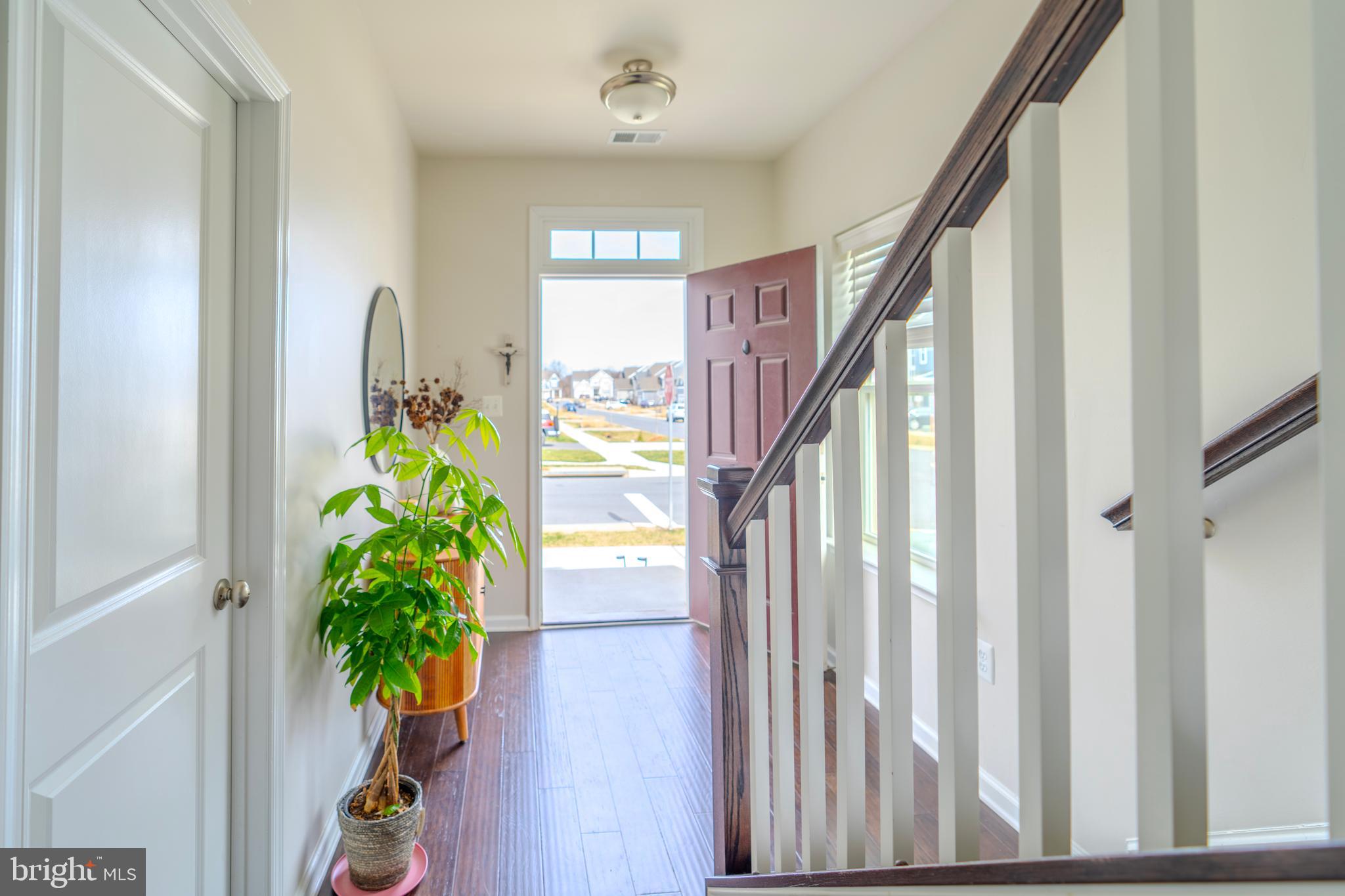 8515 Bald Eagle Lane Frederick, MD 21704 - Photo 4 of 34 a view of a hallway with wooden floor and stairs