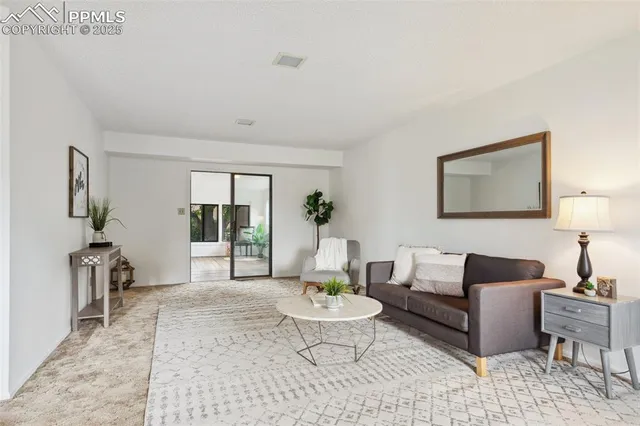 a living room with furniture and a rug