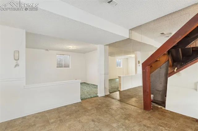 a view of an empty room with a window