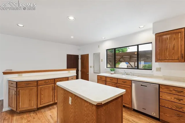 a kitchen with a sink cabinets and wooden floor