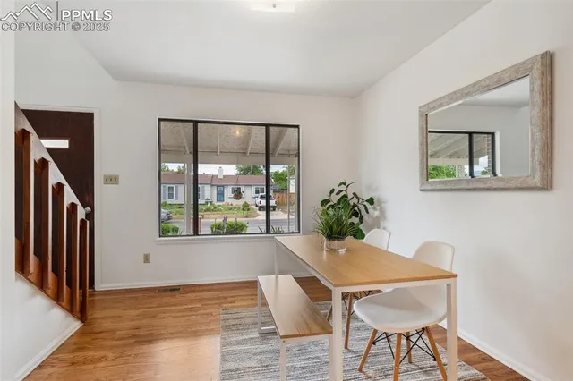 a view of a livingroom with furniture wooden floor and a window