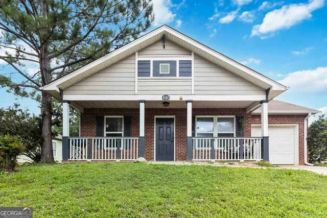 a view of a house with a yard and garden