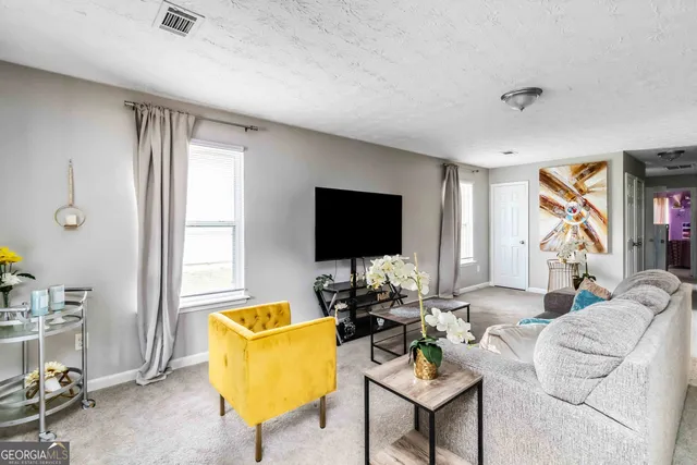 a living room with furniture and a flat screen tv