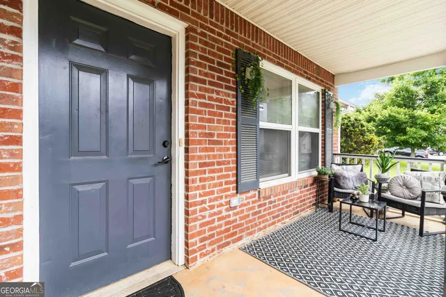 a view of a house with backyard and sitting area