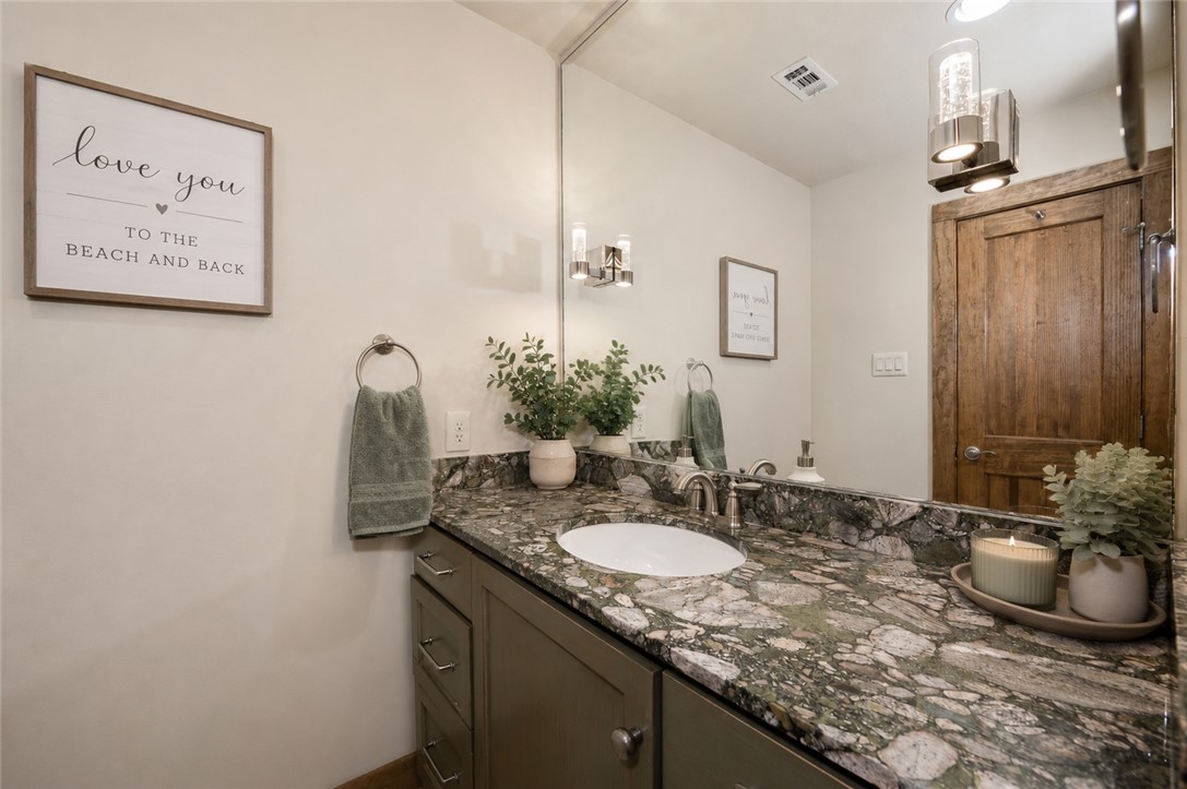 2302 Quail Run College Station, TX 77845 - Photo 19 of 49 a bathroom with a granite countertop sink and a mirror