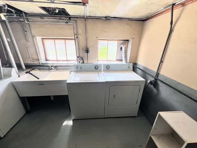 a bathroom with a double vanity sink a mirror and a bathtub