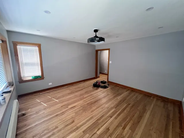 wooden floor in an empty room with a window