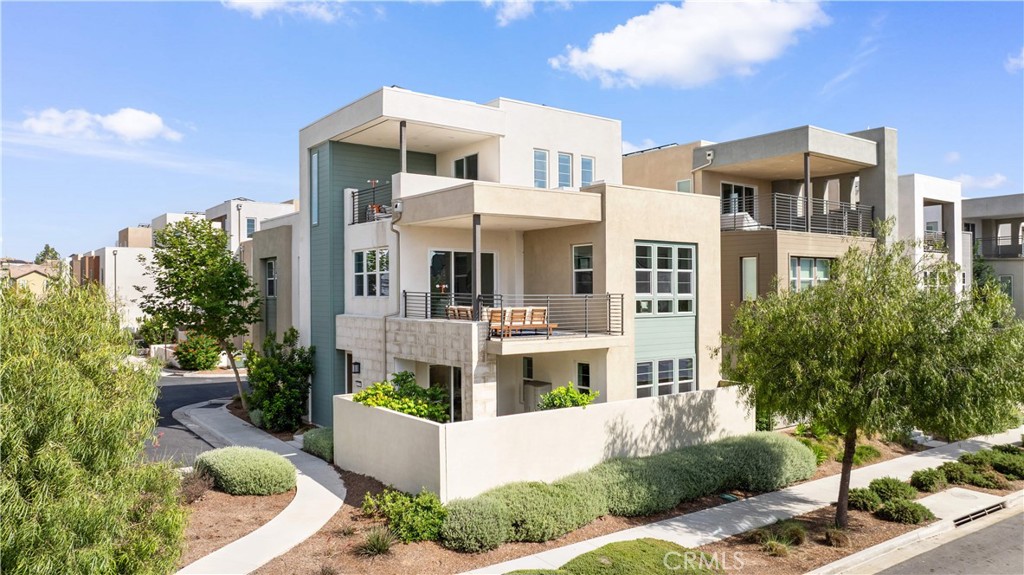 228 Merit Irvine, CA 92618 - Photo 1 of 1 a front view of a building with a garden and plants