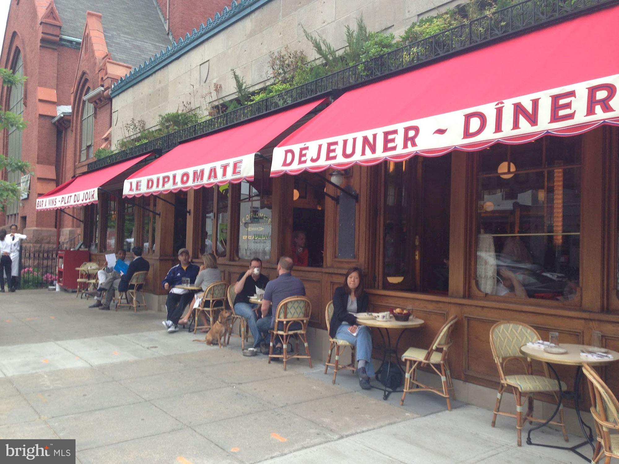 2001 16th Street Northwest, Unit 404 Washington, DC 20009 - Photo 13 of 17 a view of a cafe with a couple of people in a patio