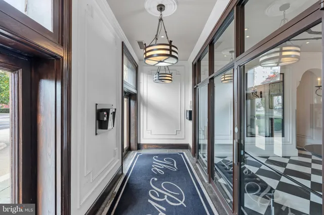 a view of a hallway with wooden floor and windows