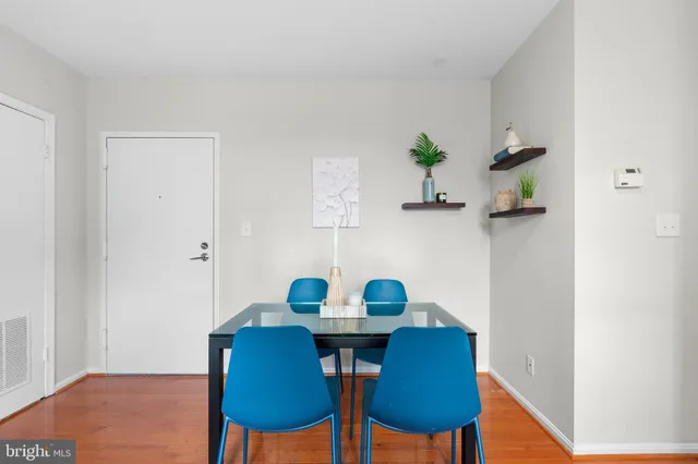 a view of a dining room with furniture and wooden floor