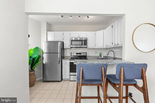a kitchen with a refrigerator a stove a microwave and cabinets