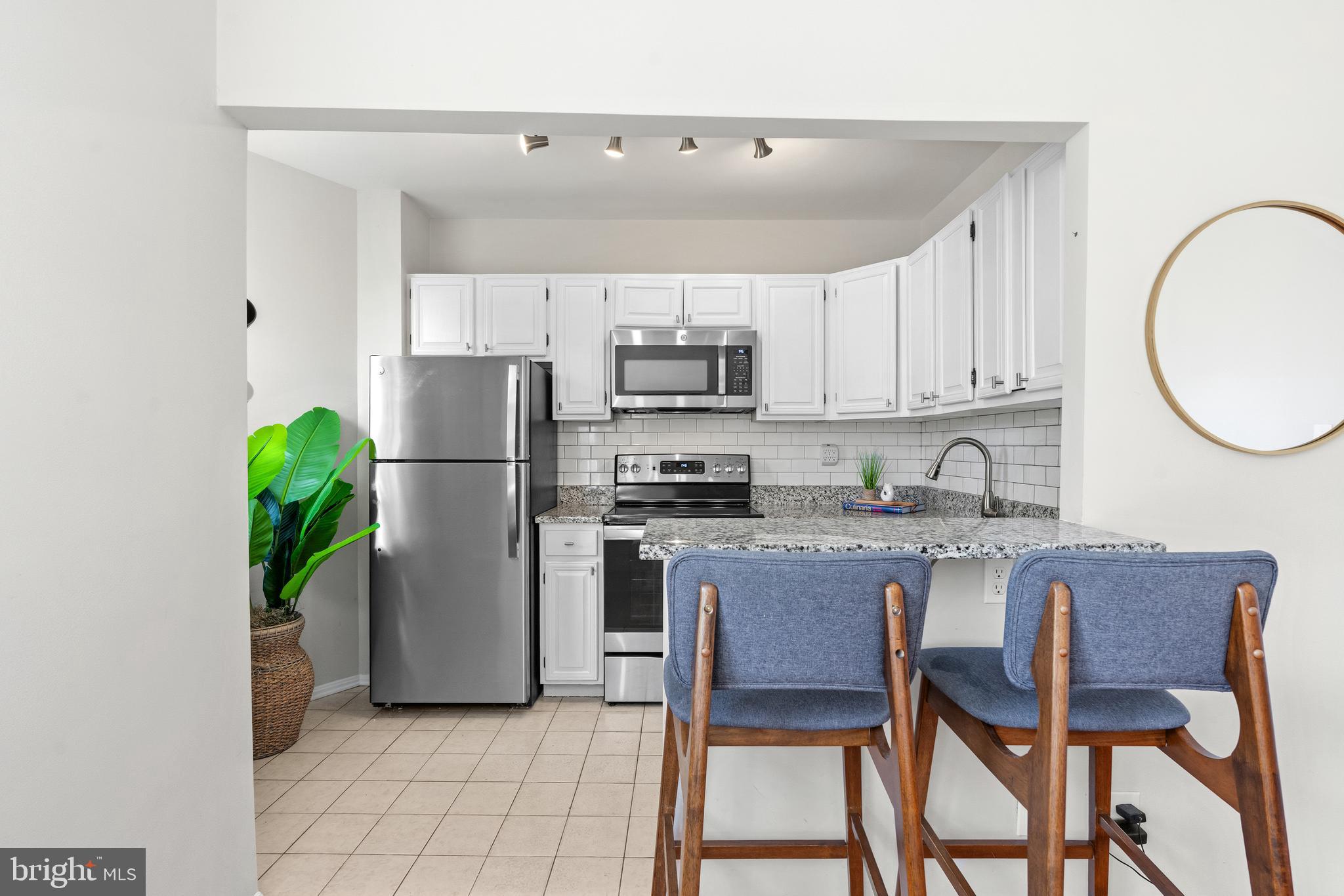 2001 16th Street Northwest, Unit 404 Washington, DC 20009 - Photo 9 of 17 a kitchen with a refrigerator a stove a microwave and cabinets
