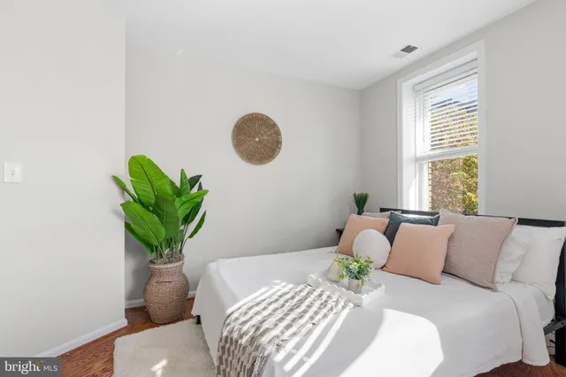 a bedroom with a bed and a window