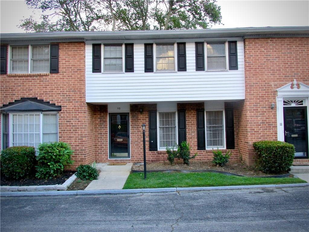 6520 Roswell Road, Unit 110 Atlanta, GA 30328 - Photo 1 of 1 front view of a brick house with a yard