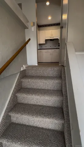 a view of a room with wooden floor and a window