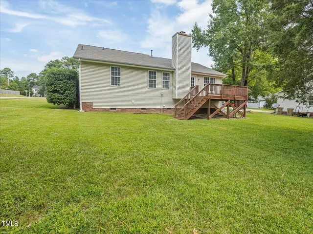 a view of a house with a yard and sitting area