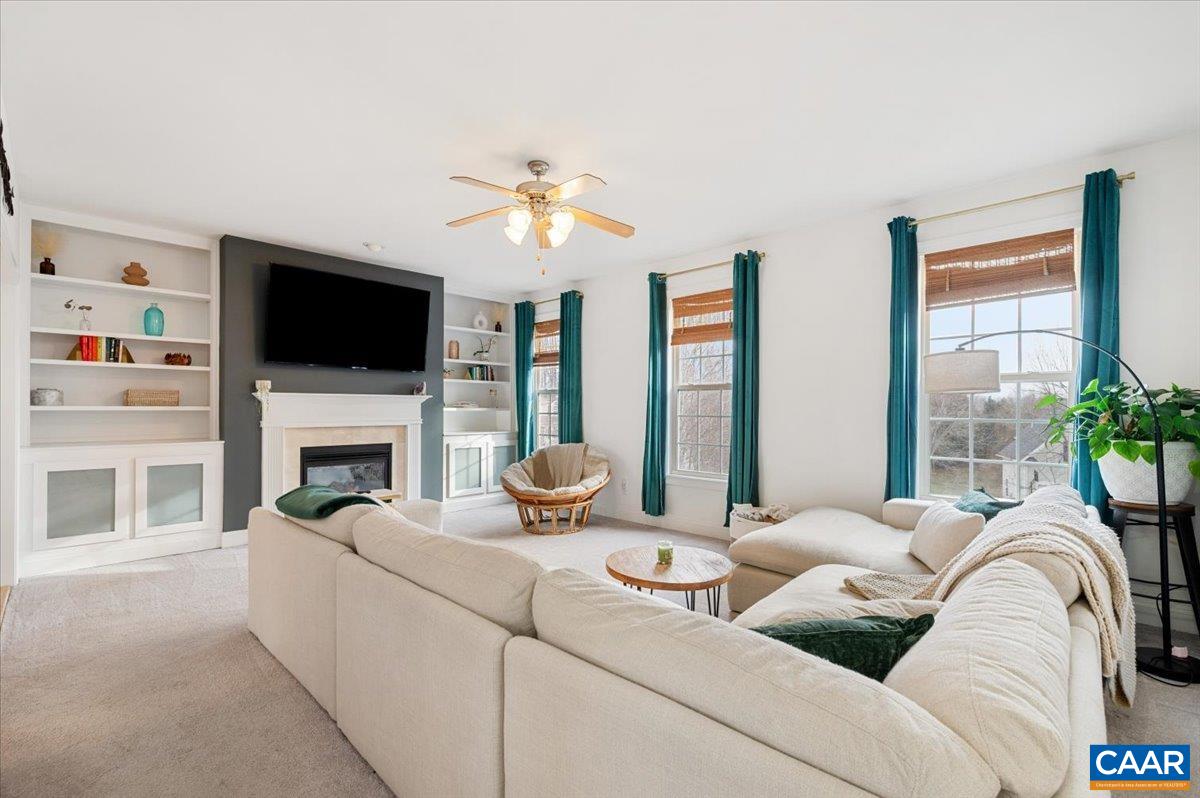 1375 Amber Ridge Road Charlottesville, VA 22901 - Photo 12 of 48 a living room with furniture a fireplace and a flat screen tv