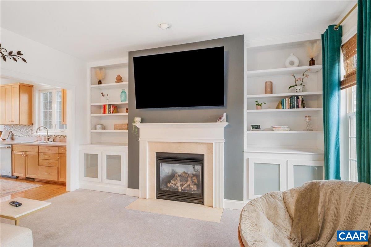 1375 Amber Ridge Road Charlottesville, VA 22901 - Photo 13 of 48 a living room with a fireplace and a flat screen tv