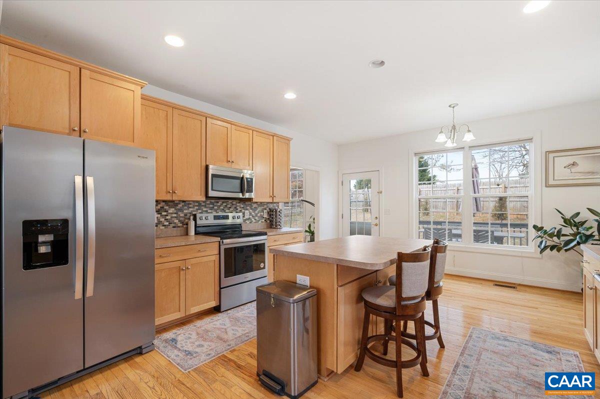 1375 Amber Ridge Road Charlottesville, VA 22901 - Photo 18 of 48 a kitchen with a table chairs refrigerator and microwave