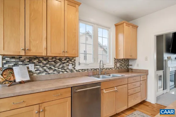 a kitchen with stainless steel appliances granite countertop a sink a stove and cabinets
