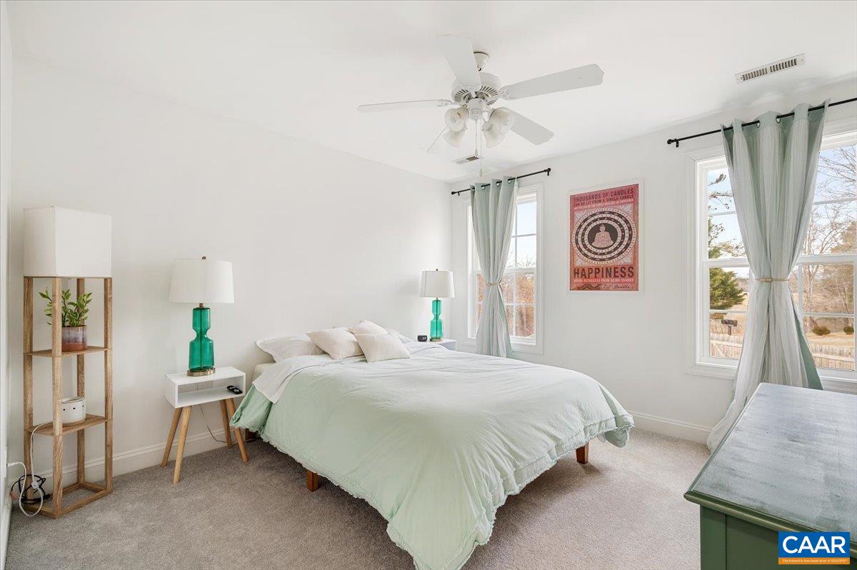 1375 Amber Ridge Road Charlottesville, VA 22901 - Photo 37 of 48 a bedroom with a bed and a chandelier