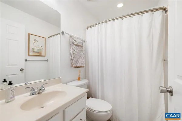 a bedroom with a bed dresser and a large mirror