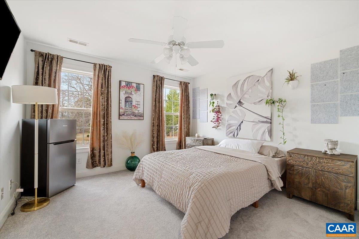 1375 Amber Ridge Road Charlottesville, VA 22901 - Photo 40 of 48 a bedroom with a bed dresser and a large mirror