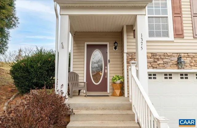a view of staircase with wooden floor and white walls