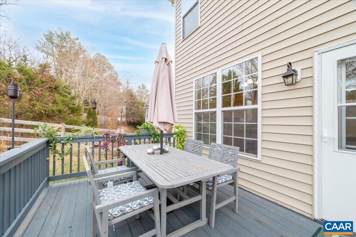 1375 Amber Ridge Road Charlottesville, VA 22901 - Photo 43 of 48 a view of a roof deck with table and chairs with wooden floor and fence