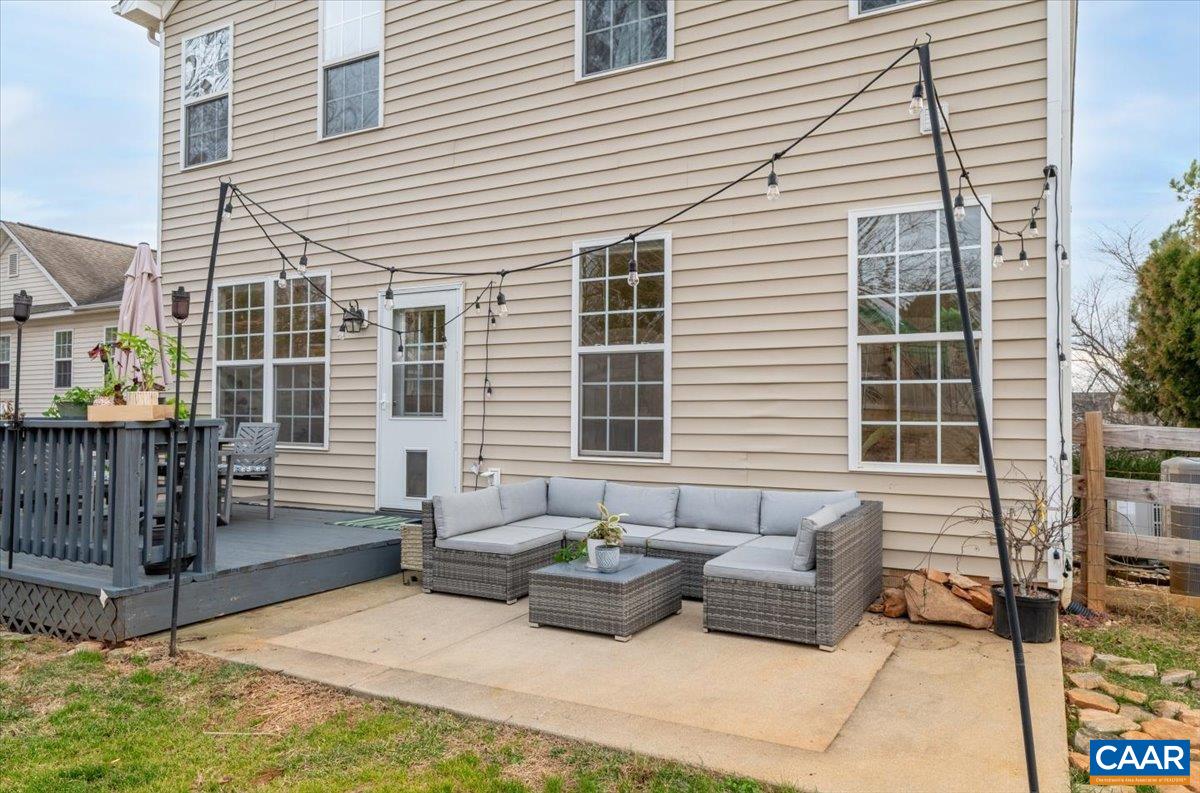 1375 Amber Ridge Road Charlottesville, VA 22901 - Photo 45 of 48 a view of a patio with couches table and chairs and potted plants
