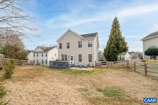 a view of house with swimming pool and a yard