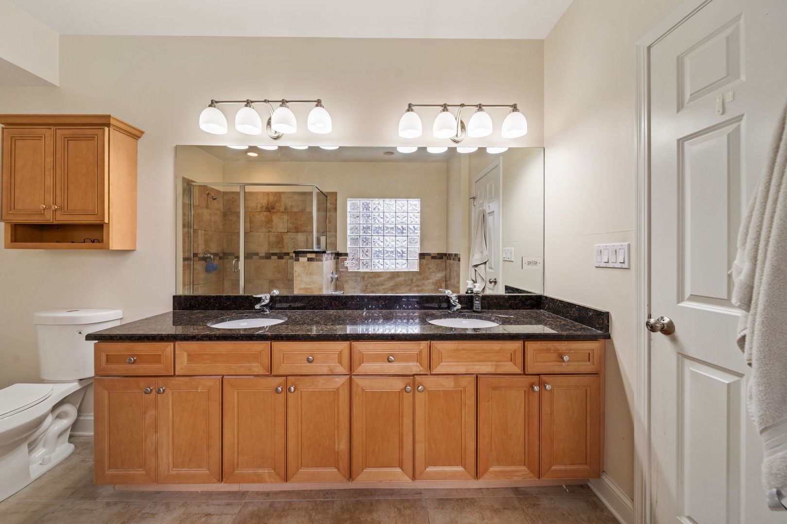 3213 South Wells Street, Unit 1 Chicago, IL 60616 - Photo 11 of 28 a bathroom with a granite countertop sink a mirror and a vanity