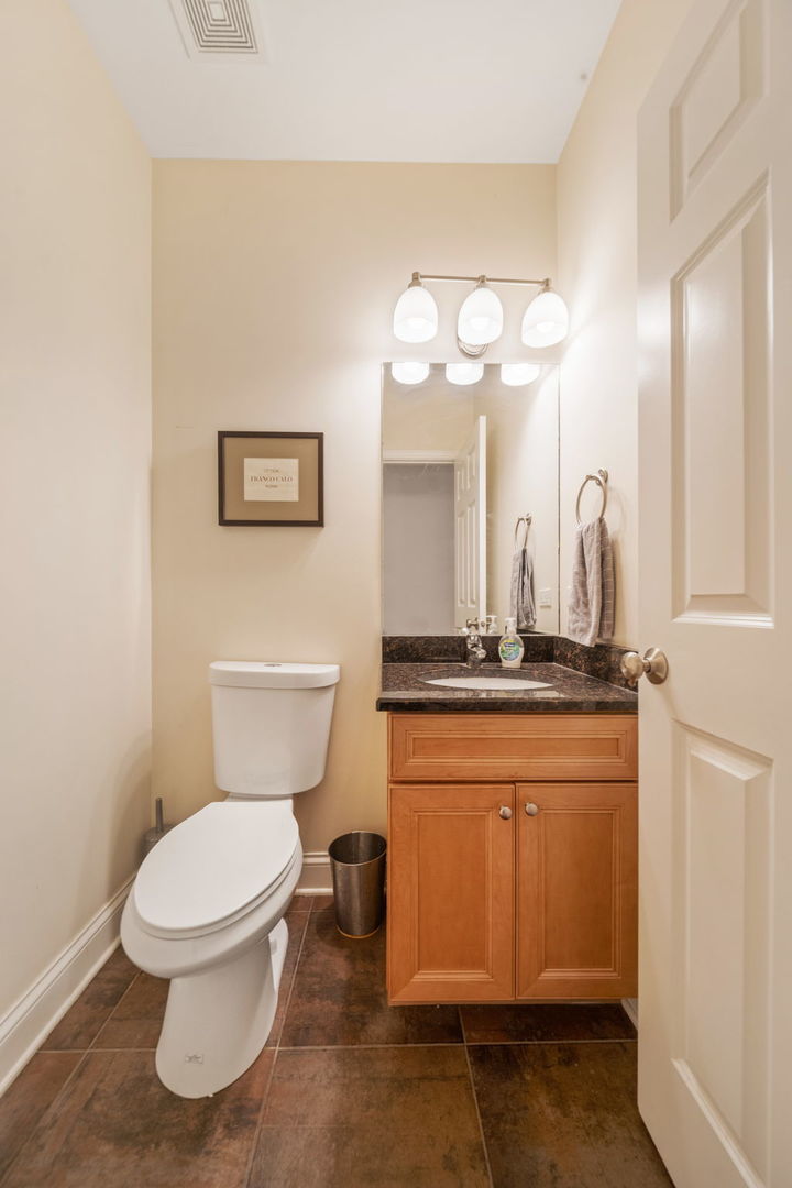 3213 South Wells Street, Unit 1 Chicago, IL 60616 - Photo 12 of 28 a bathroom with a toilet sink and mirror
