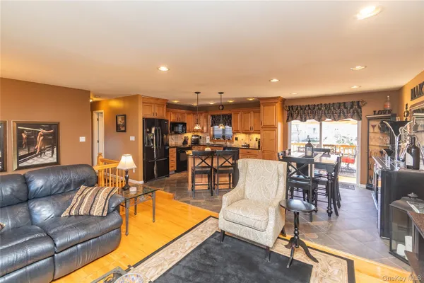 a living room with furniture and kitchen view