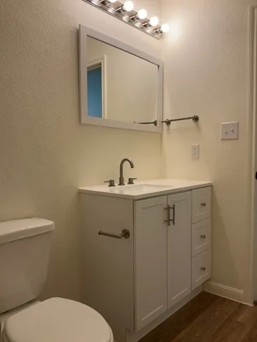 a bathroom with a toilet sink and mirror