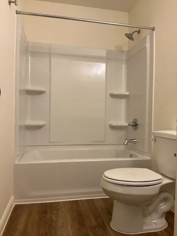 a bathroom with a toilet and a shower