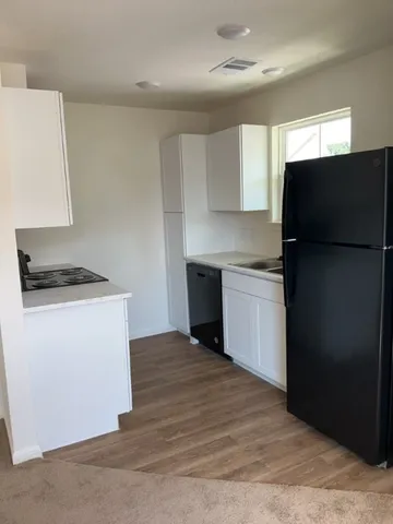 a kitchen with a refrigerator and a stove