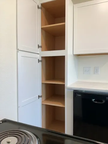 a view of walk in closet with clothes