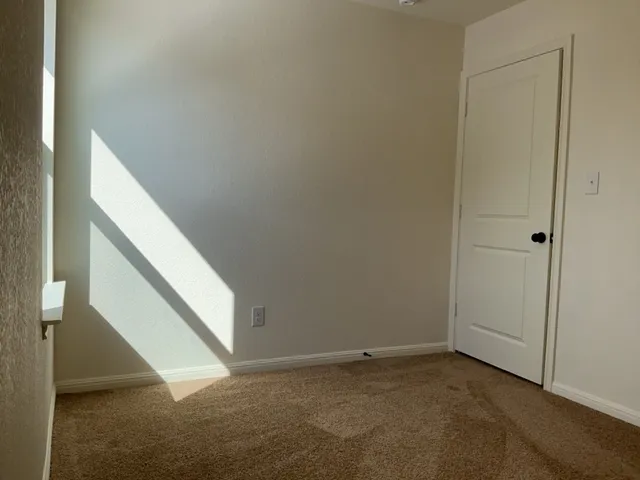 a view of an empty room with stairs