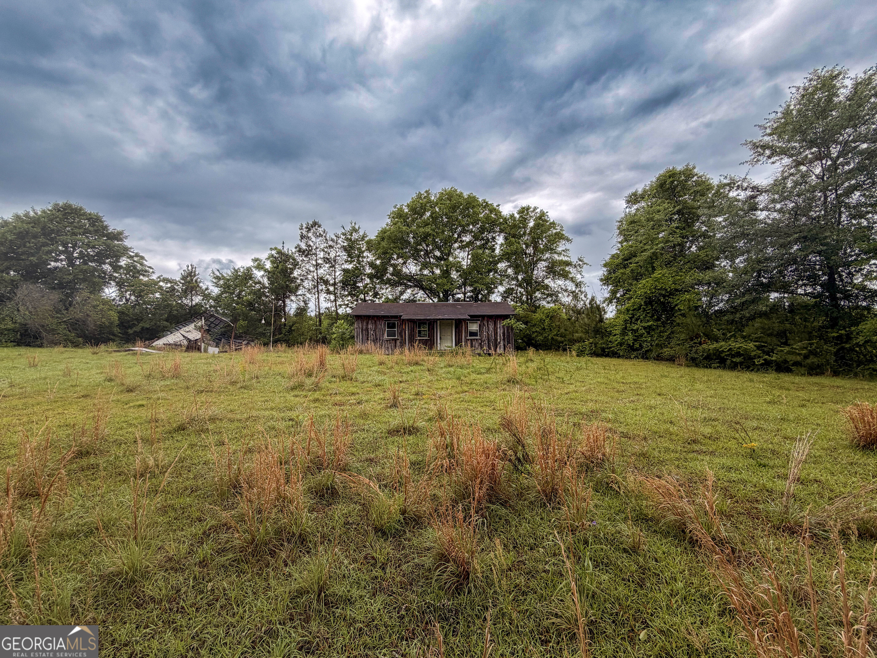 3925 Highway 441 Rentz, GA 31075 - Photo 2 of 16 a view of a lake with a yard
