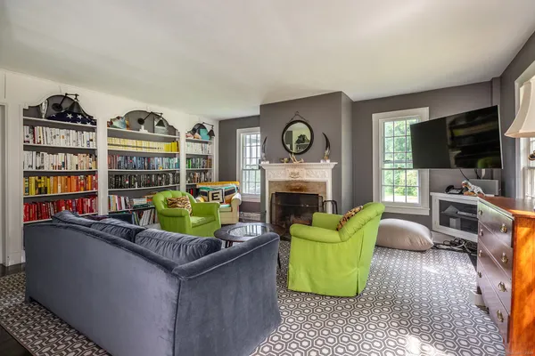 a living room with fireplace furniture and a flat screen tv
