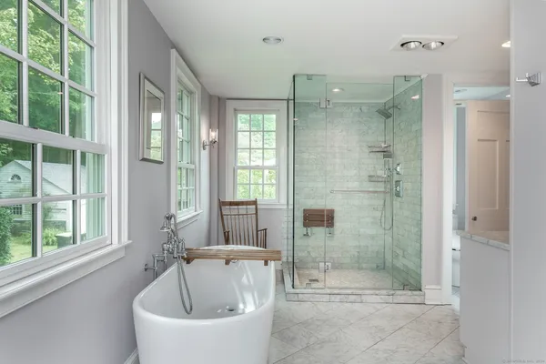a bathroom with a bathtub and shower