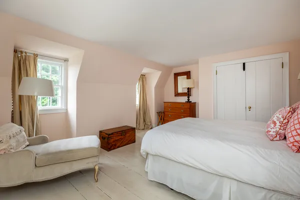 a bedroom with a bed and a couch