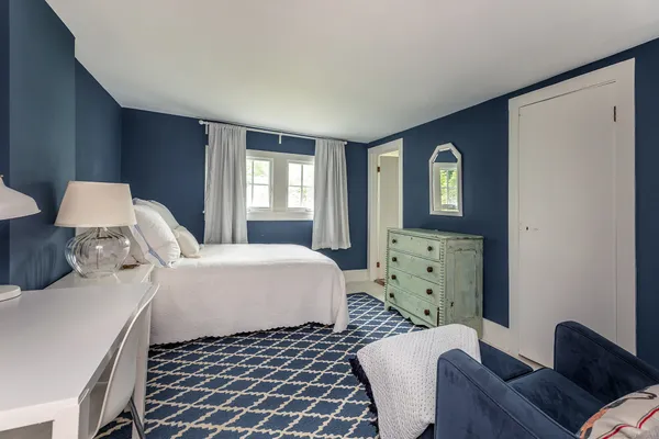 a bedroom with a bed and a couch