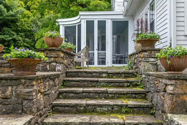 a front view of a house with potted plants