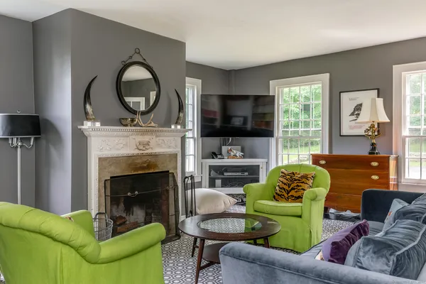 a living room with furniture a flat screen tv and a fireplace