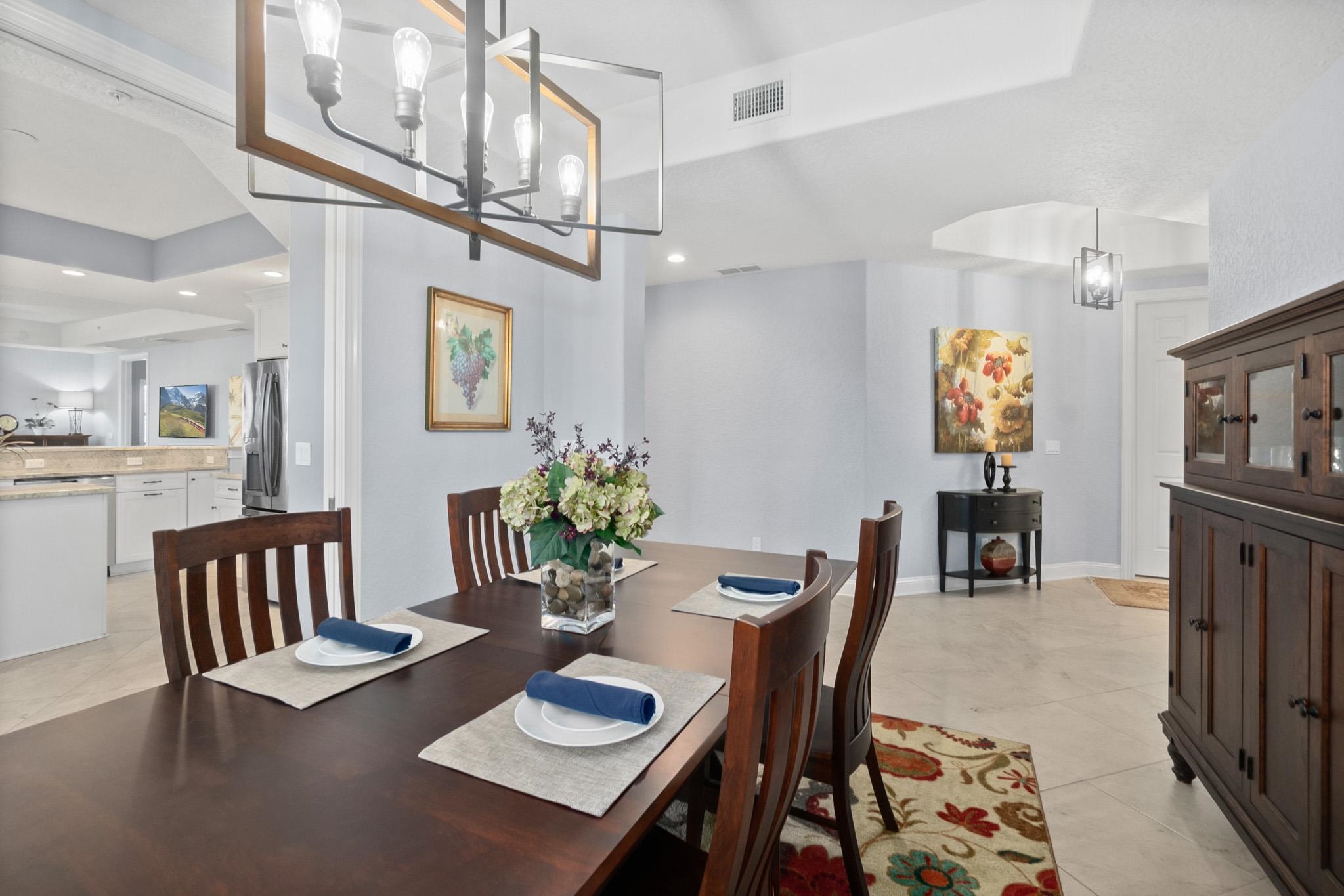 131 Laterra Links Circle, Unit 101 St. Augustine, FL 32092 - Photo 11 of 60 a view of a dining room with furniture and chandelier