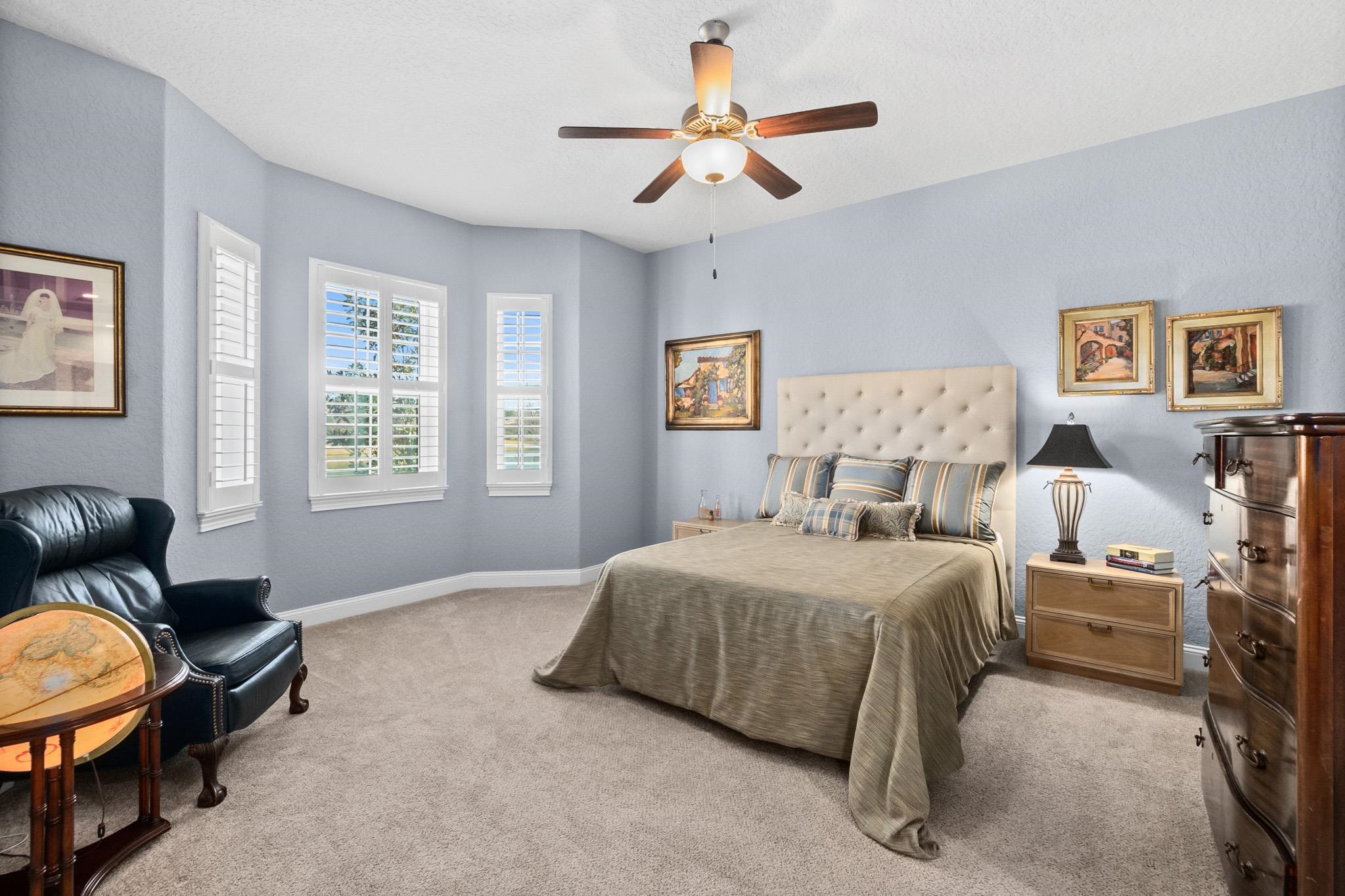131 Laterra Links Circle, Unit 101 St. Augustine, FL 32092 - Photo 29 of 60 a bedroom with a bed a couch and a window